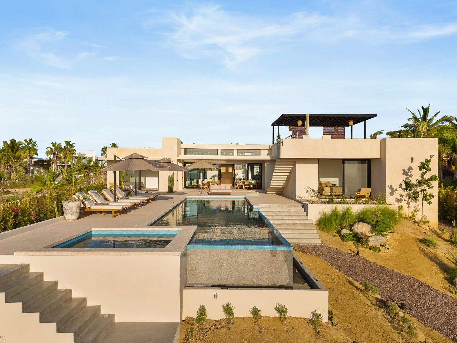 Maravilla Las Tunas The Nacuii Residence is a refined luxury home crafted to exceed the expectations of even the most discerning buyer. Nestled on a generous and private 3,000 m² lot (0.73 acres), it's just a short, effortless stroll to the untouched, sandy shores of Las Tunas — perfect for enjoying the serene coastal landscape and dramatic sunsets. The home offers a thoughtful layout with 3 spacious bedrooms, a separate studio, a cozy TV lounge, and 6 full bathrooms, including two principal suites, a guest room, a detached studio, and a dedicated media or family room. Expansive sliding glass doors invite natural light throughout the interiors while showcasing tranquil garden for sale
