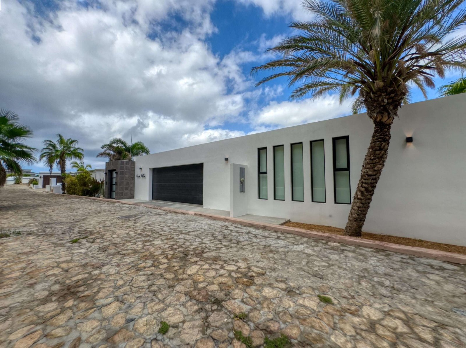 Maravilla Las Tunas The Nacuii Residence is a refined luxury home crafted to exceed the expectations of even the most discerning buyer. Nestled on a generous and private 3,000 m² lot (0.73 acres), it's just a short, effortless stroll to the untouched, sandy shores of Las Tunas — perfect for enjoying the serene coastal landscape and dramatic sunsets. The home offers a thoughtful layout with 3 spacious bedrooms, a separate studio, a cozy TV lounge, and 6 full bathrooms, including two principal suites, a guest room, a detached studio, and a dedicated media or family room. Expansive sliding glass doors invite natural light throughout the interiors while showcasing tranquil garden for sale