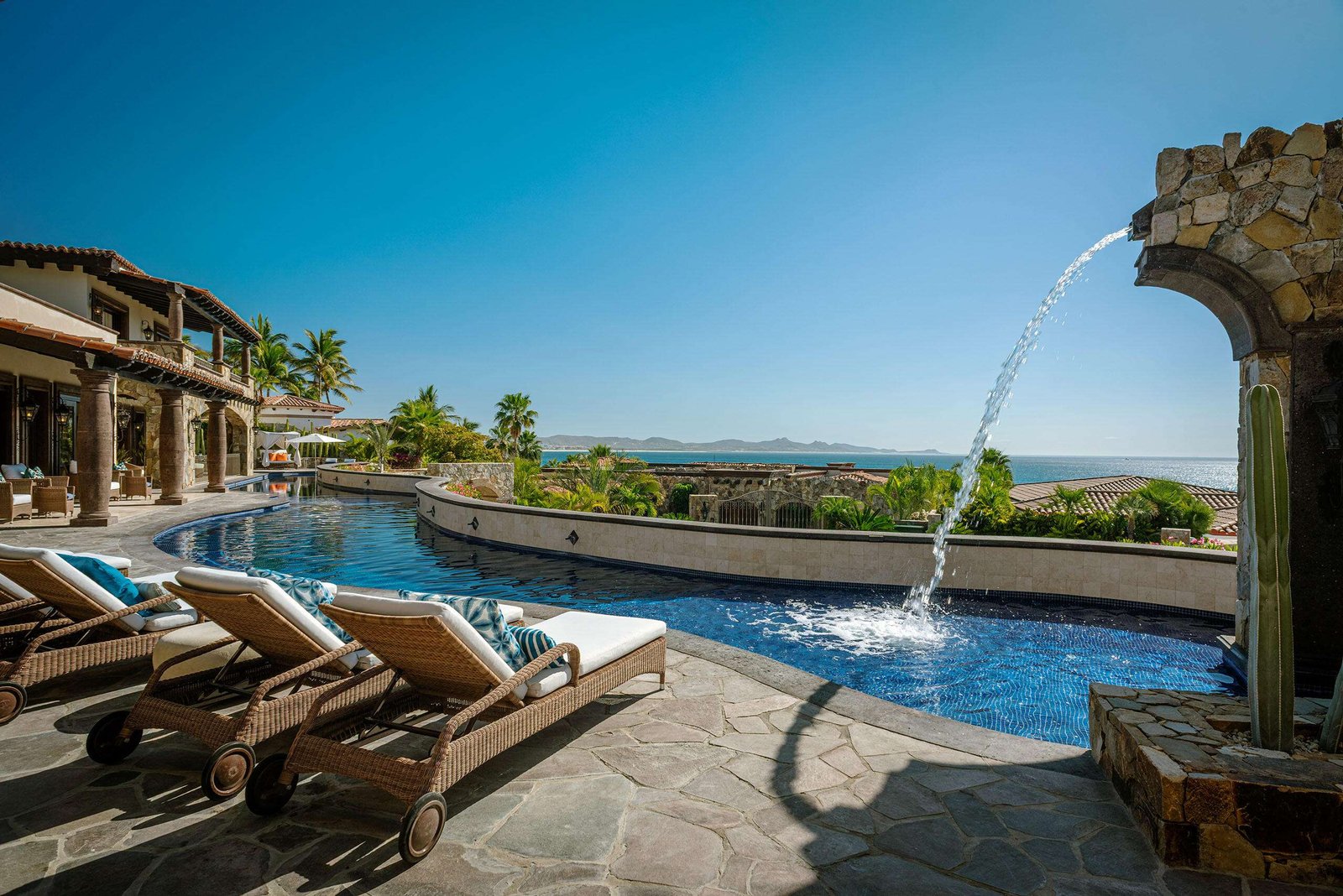 Maravilla Palmilla Cove Villa Encanto, located at Palmilla Cove 5, offers a traditional design with hints of Old Hacienda Architecture, captured in the stone façade and archways throughout. The home offers a calming neutral palette, comfort, and practicality.A bit of wow comes into play with the 100' plus sprawling pool. Flowing the length of the home, the pool features a centrally located sunken spa, wet shelf, spitter fountains and cascading waterfall. Multi outdoor gathering spots are scattered throughout, offering places for lounging or leisurely long lunches, and even sneaking away to a quiet spot.The approach with the interior was to capture the ocean – Villa Encanto, Palmilla Cove 5, San Jose Corridor, San Jose Corridor, BS